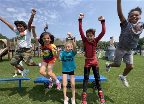  Kids jumping off a bench on playground